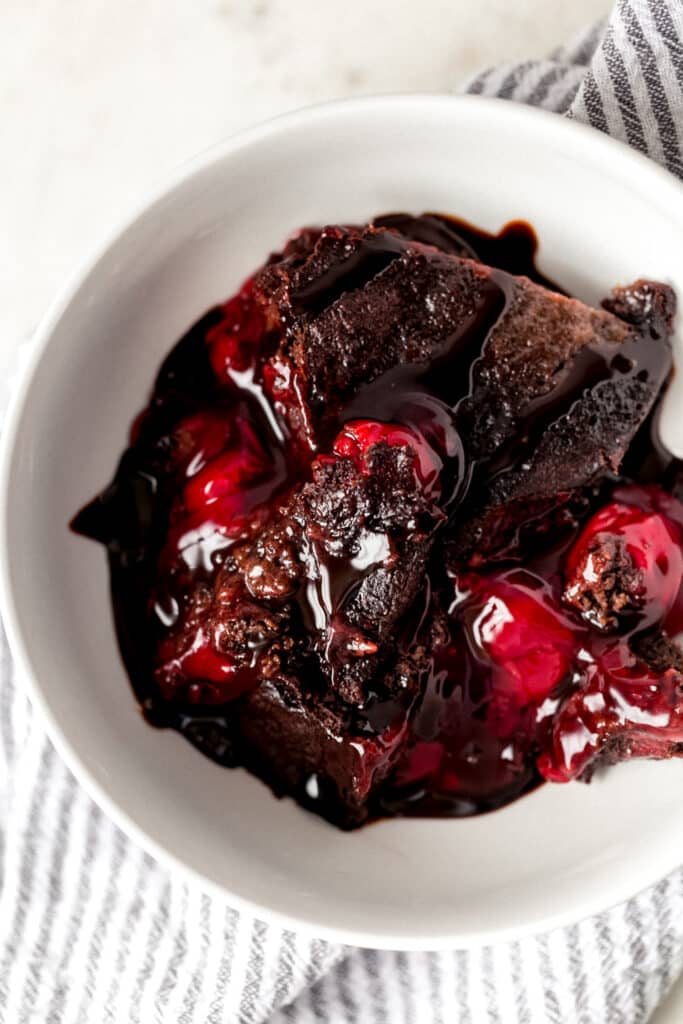 overhead view instant pot chocolate cherry dump cake in small white bowl with napkin