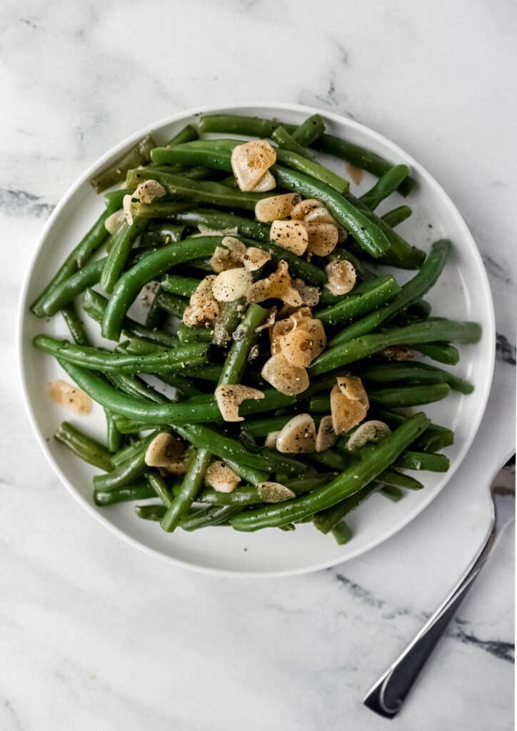finished green beans on white dinner plate