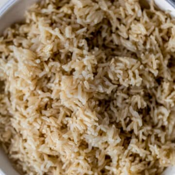 cooked brown rice in large white bowl