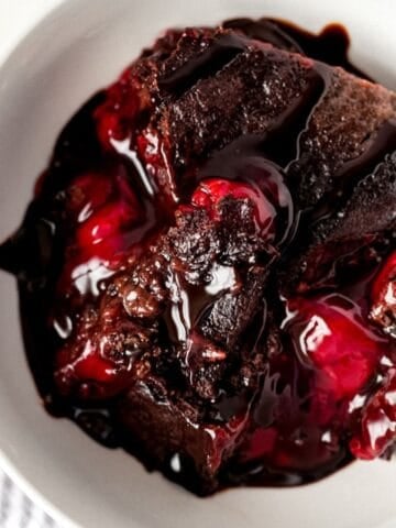 Overhead view of serving of cake in a white bowl.