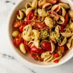 overhead view of serving of finished pasta salad in a white bowl