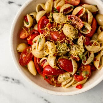 overhead view of serving of finished pasta salad in a white bowl