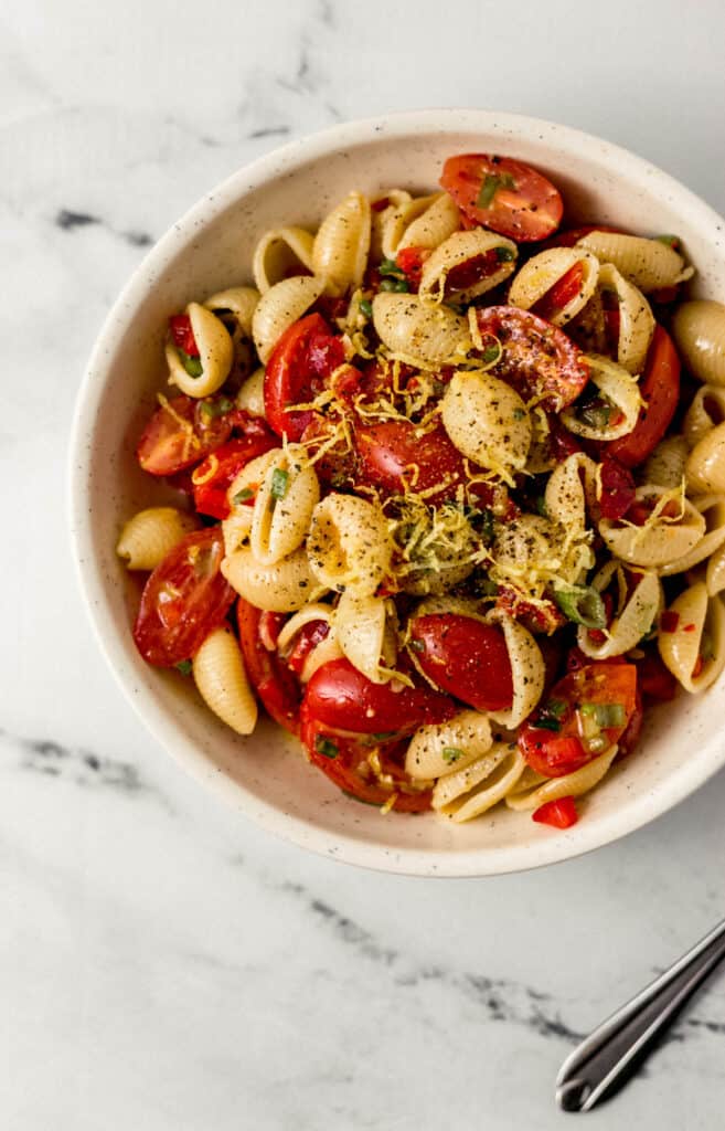 overhead view of serving of finished pasta salad in a white bowl