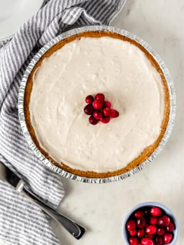 No Bake Eggnog Cheesecake topped with fresh cranberries