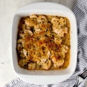 Overhead view of finished scampi in white baking dish.