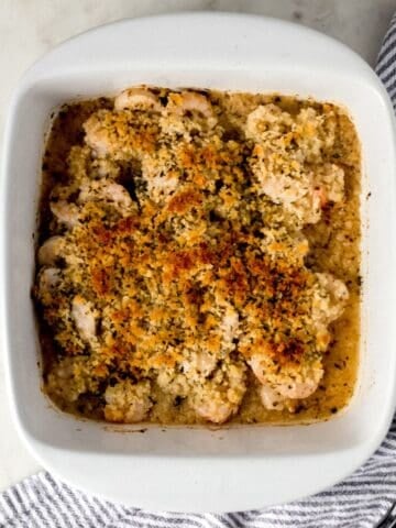 Overhead view of finished scampi in white baking dish.