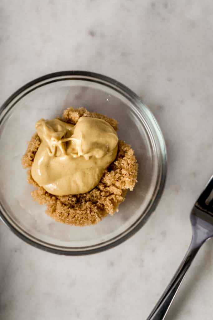 brown sugar and Dijon mustard in small glass bowl next to fork