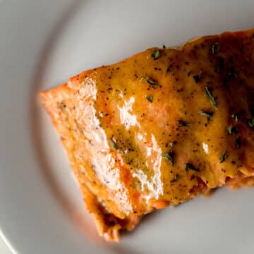 piece of brown sugar dijon glazed salmon on white plate