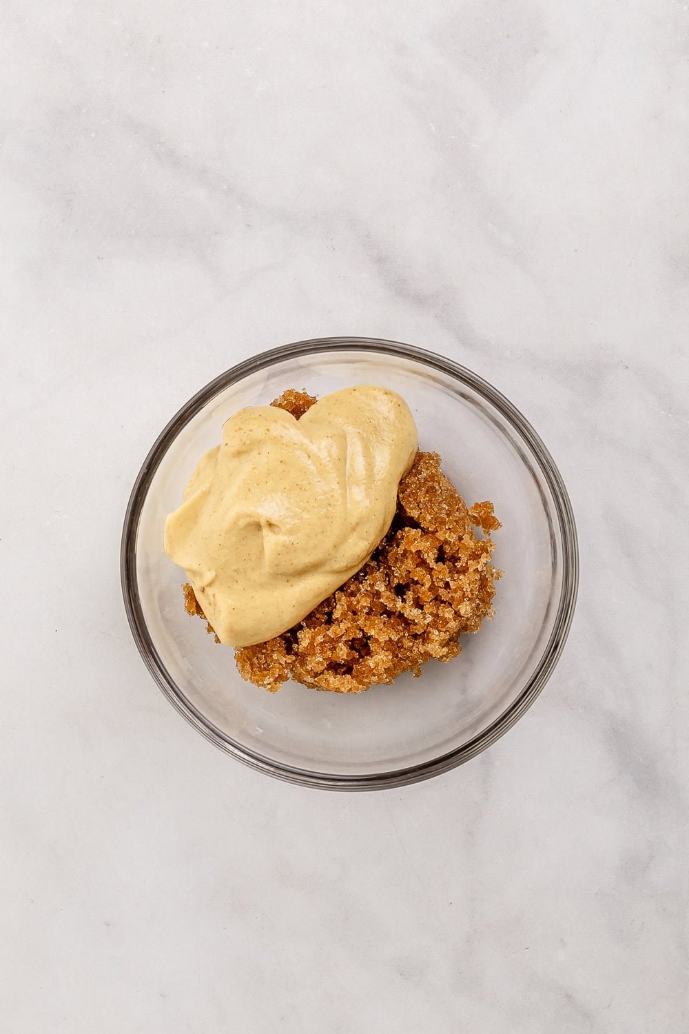 Brown sugar and dijon mustard added to small glass bowl.