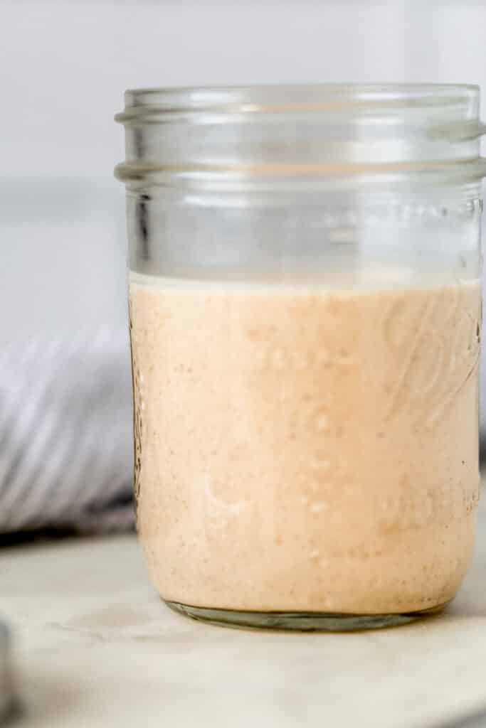 close up side view of homemade yum yum sauce in glass jar 