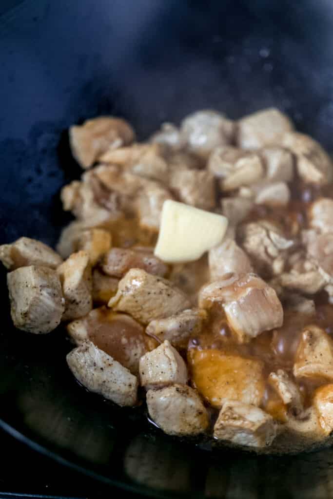 butter added to hibachi chicken in wok 