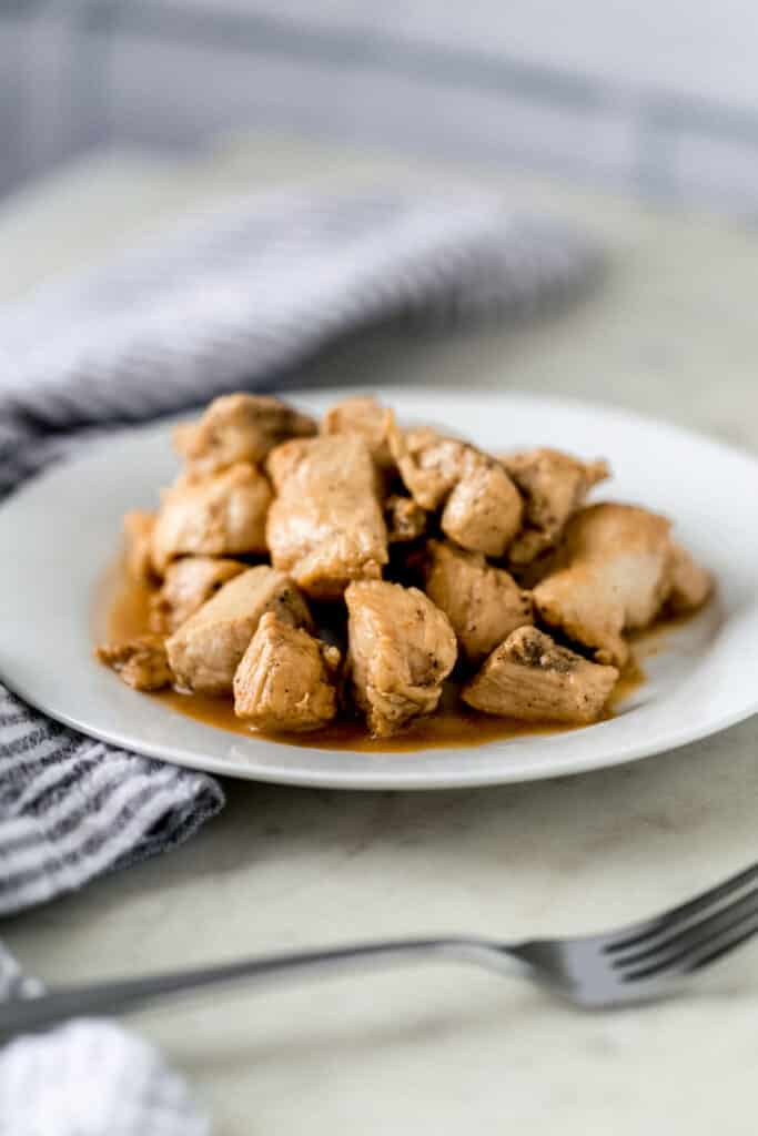 close up side view of hibachi chicken on white plate