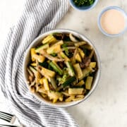 hibachi vegetables in a large white bowl with napkin and forks