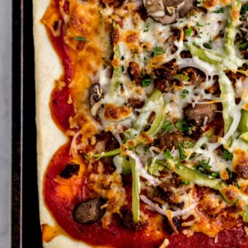 finished supreme pizza on baking sheet
