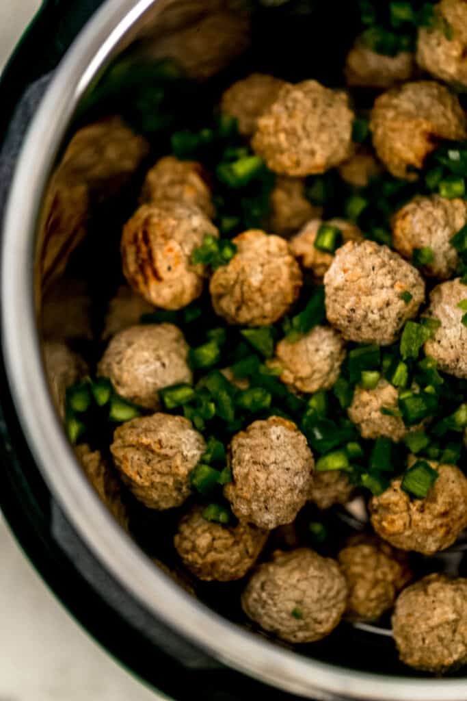 frozen meatballs and diced jalapenos inside instant pot pressure cooker 