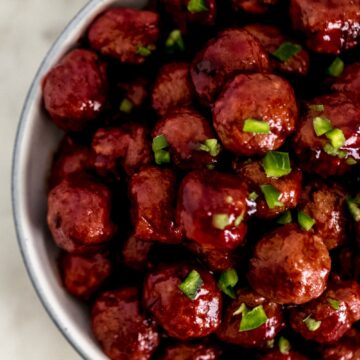 meatballs topped with chopped bell pepper in white bowl