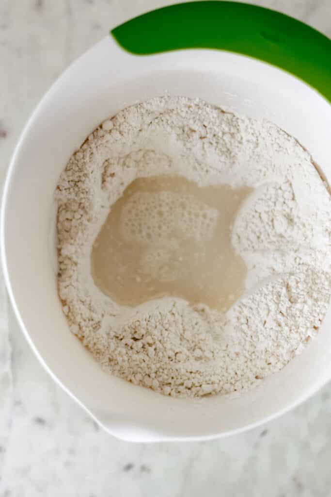 all-purpose flour, salt, and warm water in white mixing bowl 