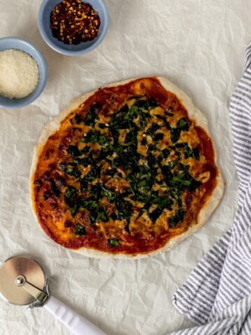 overhead view pizza with cutter and napkin