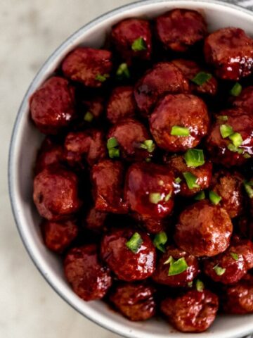 meatballs topped with chopped bell pepper in white bowl