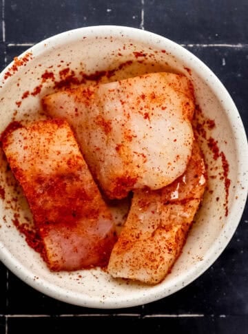 Seasoned cod in bowl.