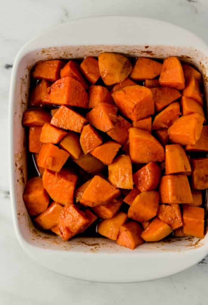 overhead view of finished candied yams in square white baking dish 