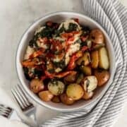 Overhead view of bowl with chicken and potatoes in it.