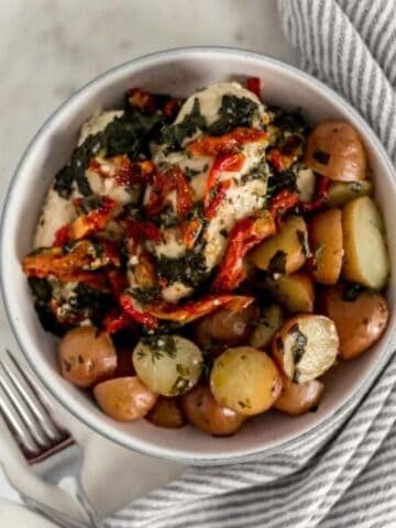 Overhead view of bowl with chicken and potatoes in it.