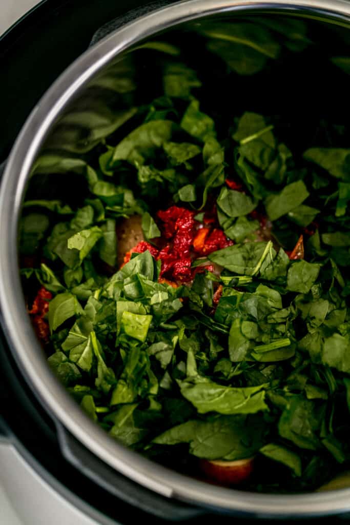 chicken breast, red potatoes, spinach, and sun dried tomatoes in pressure cooker