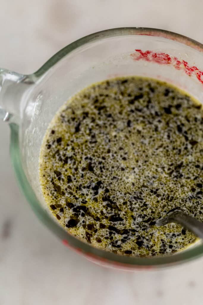 ingredients for pesto sauce in small glass pitcher