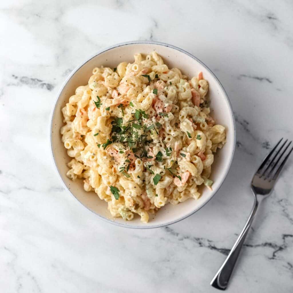 bowl of pasta salad beside a fork