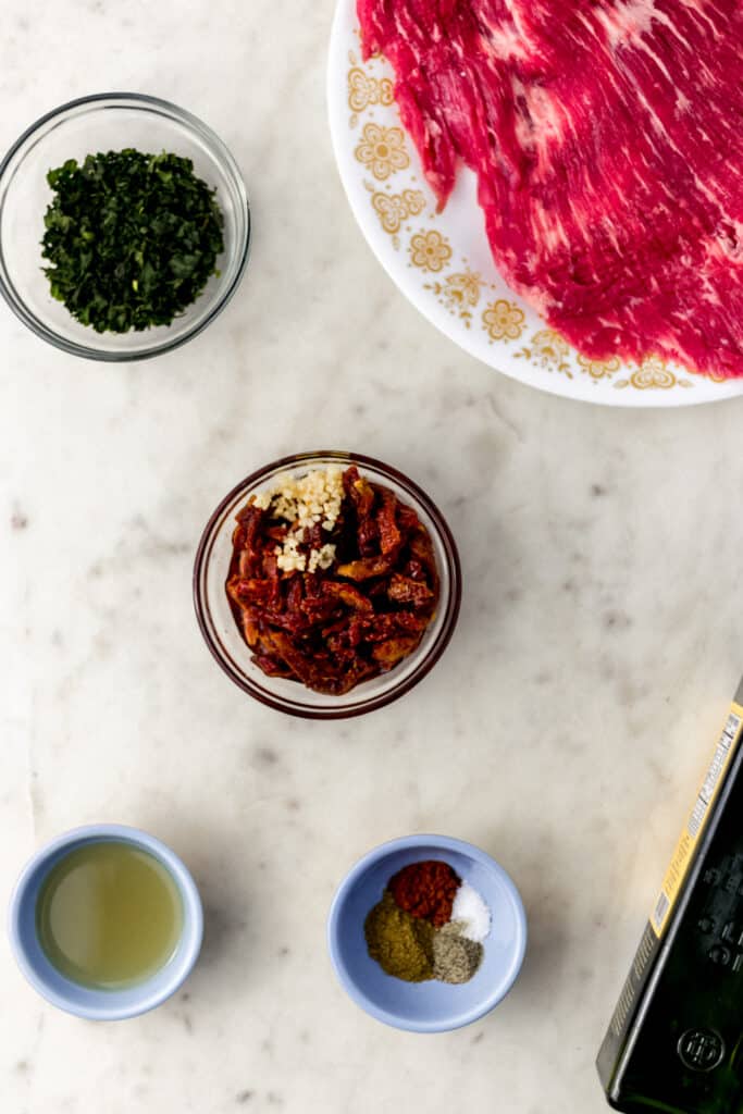 ingredients for flank steak and pesto in small bowls