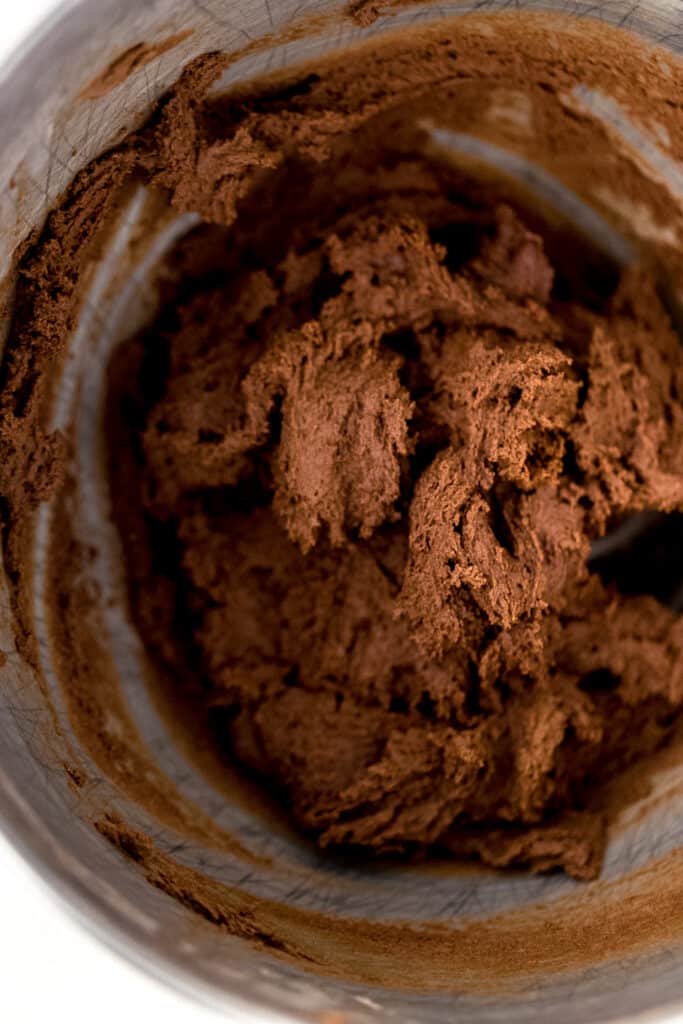 flour and cocoa mixture added to stand mixer bowl with the rest of the chocolate sugar cookie ingredients. 