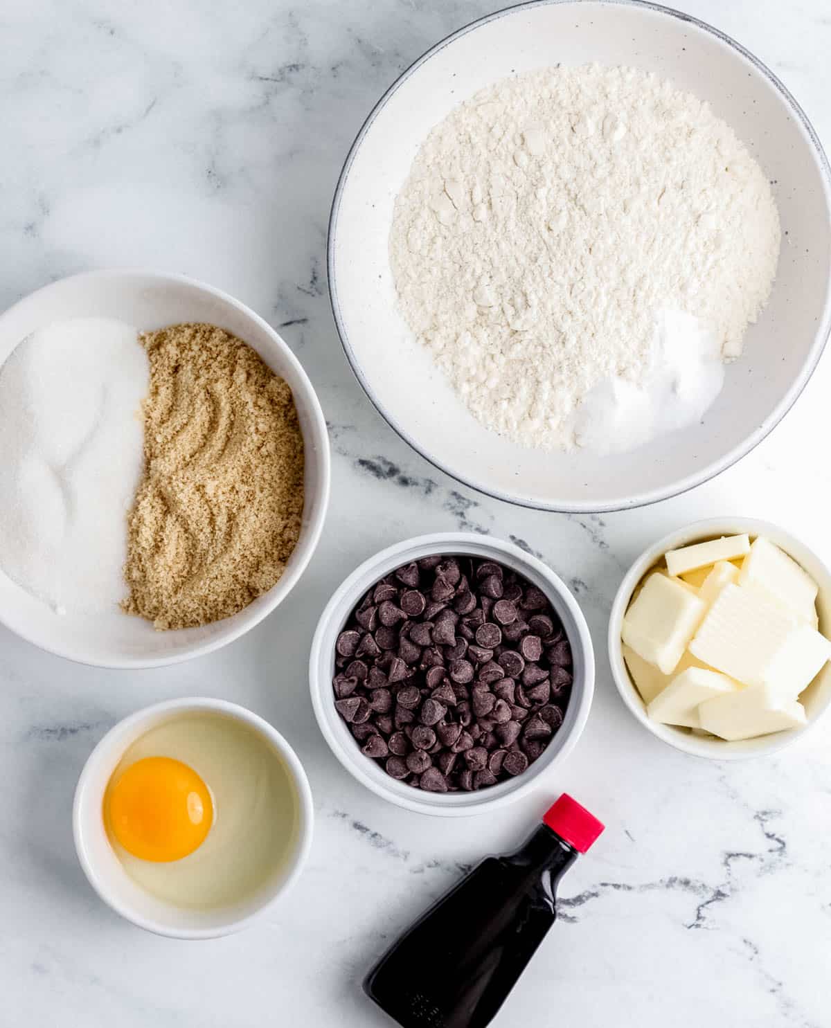 Ingredients to make cookies in separate bowls. 