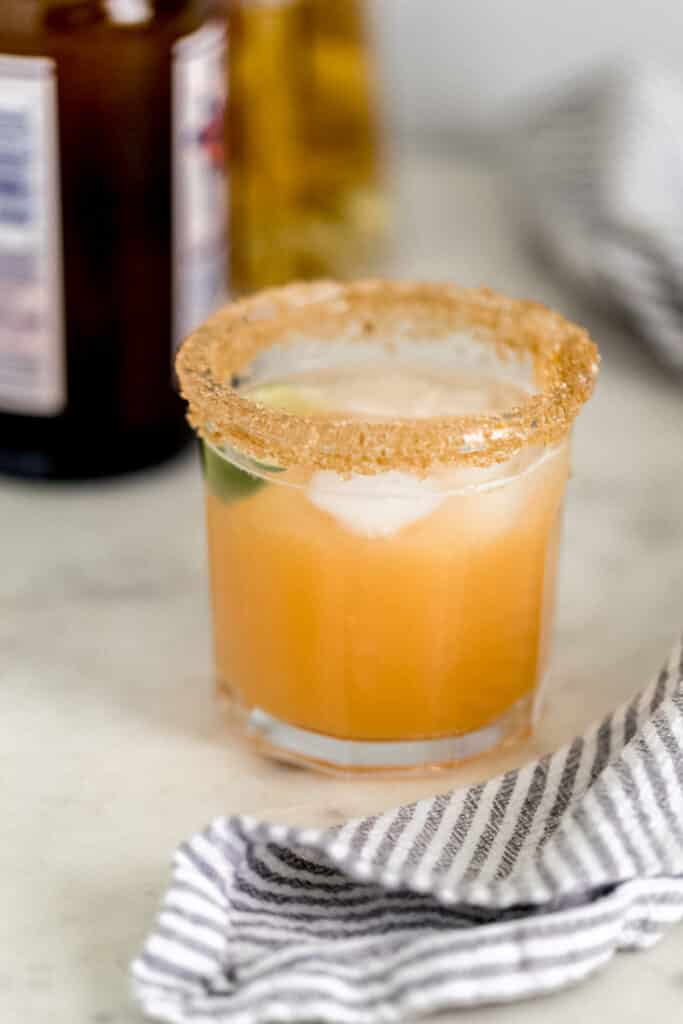 close up side view of kombucha margarita with lime wedge