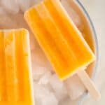 bowl with ice with peach popsicles on top