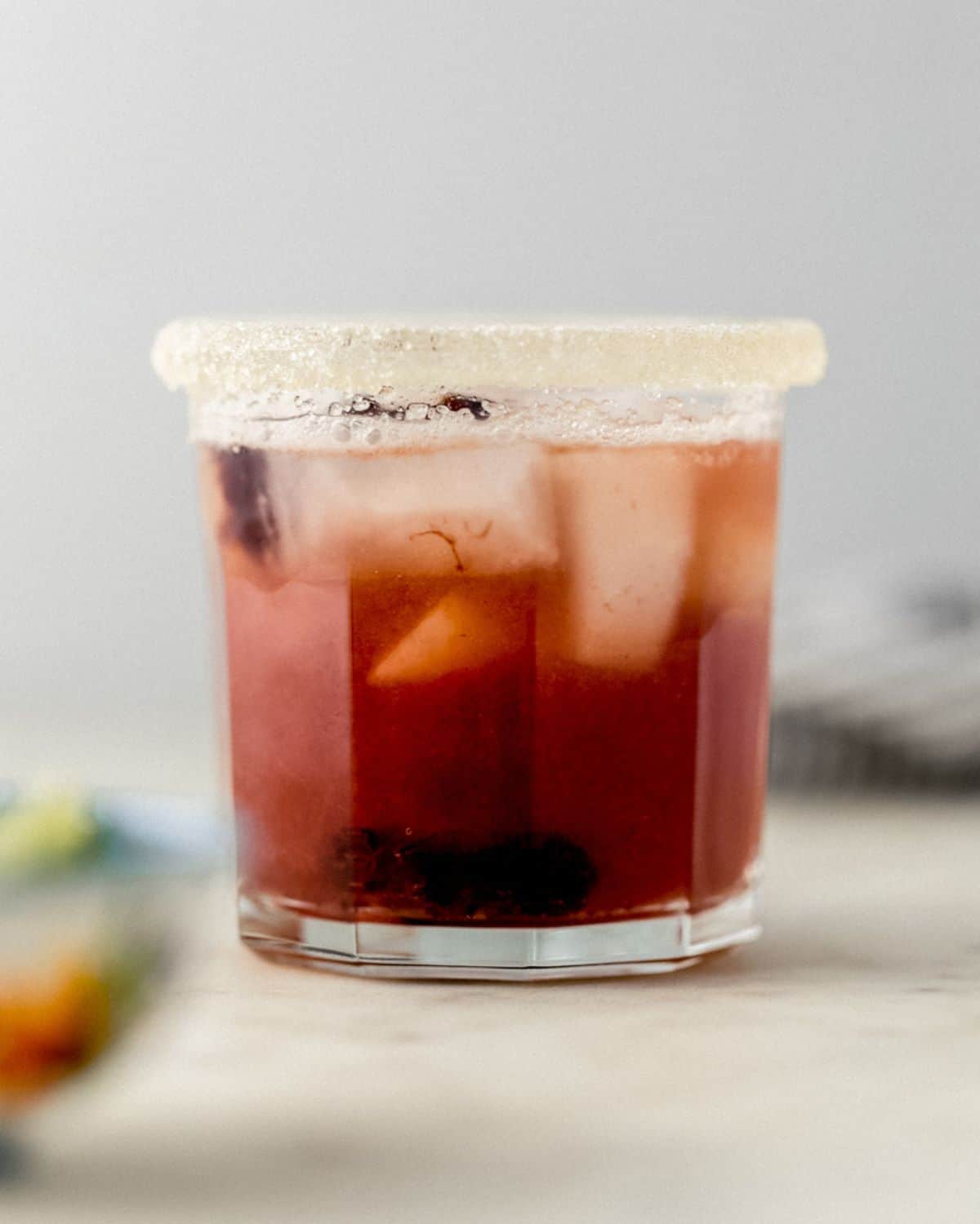 Close up side view of margarita in rimmed glass. 