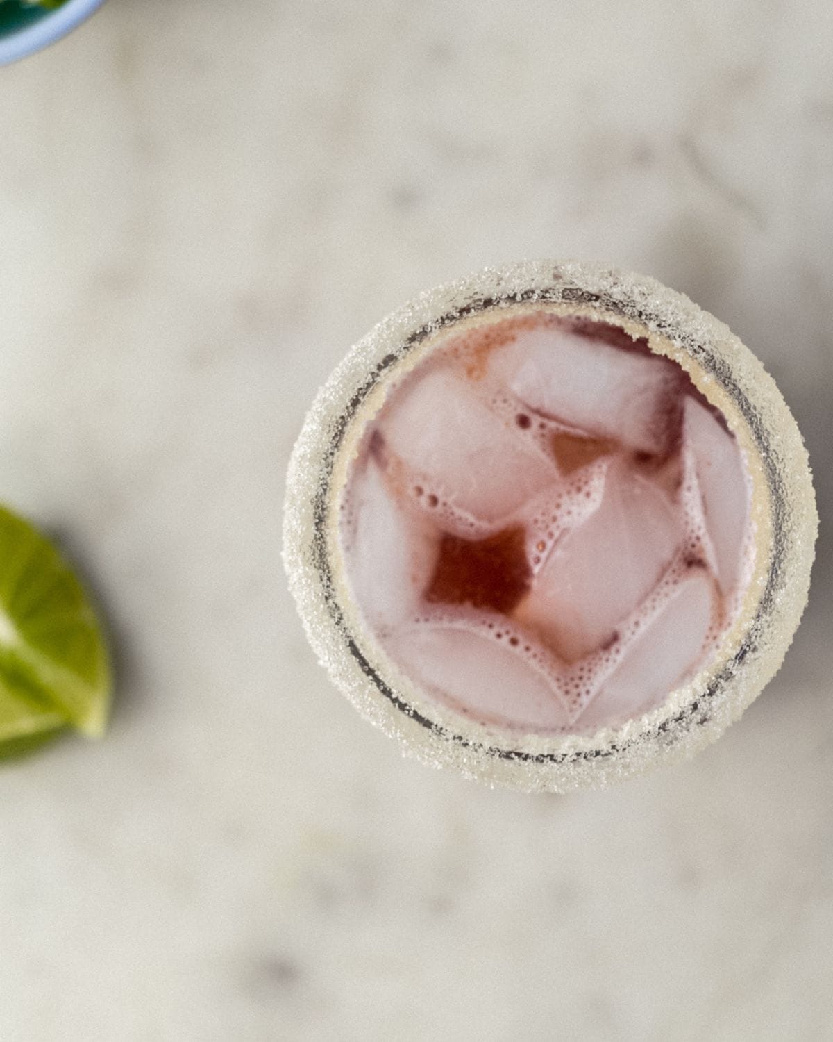 Overhead view of margarita in a glass with ice. 