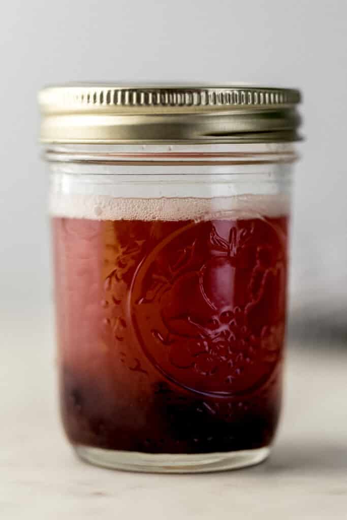 All ingredients shaken together for cherry margarita in small jar with lid on it. 