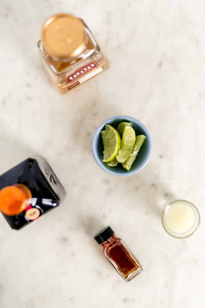 ingredients for original margarita in containers on marble