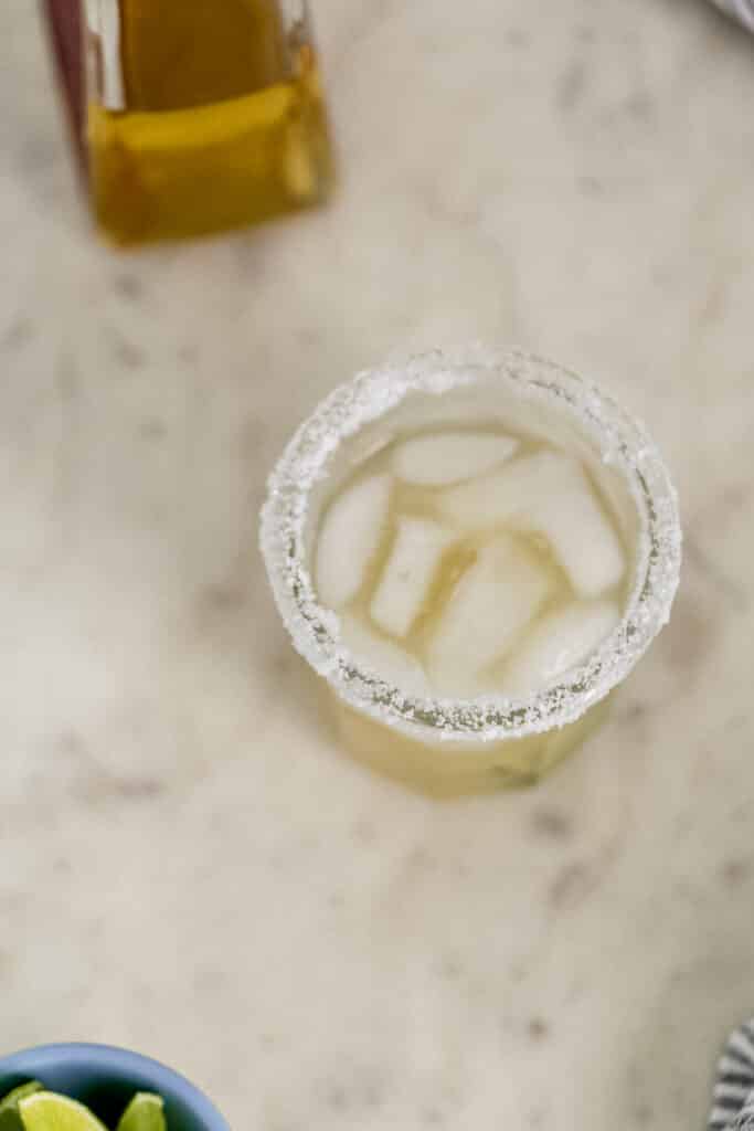 salt rimmed glass with margarita in it.