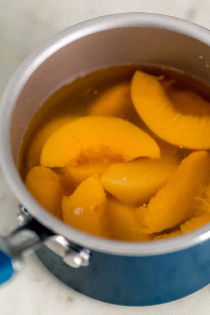 ingredients for peach tea simple syrup in sauce pan 