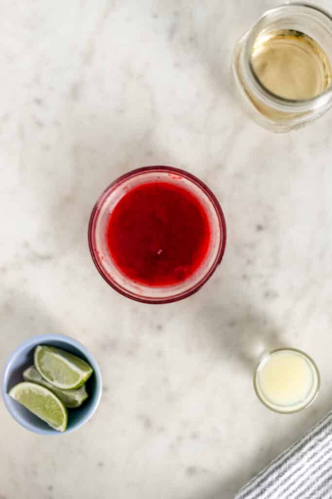 ingredients for strawberry margarita in separate containers 