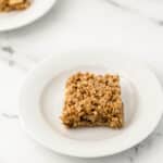 a single apple crumble bar on white plate
