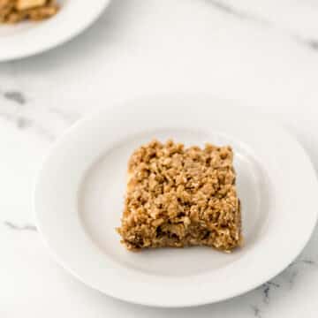 a single apple crumble bar on white plate