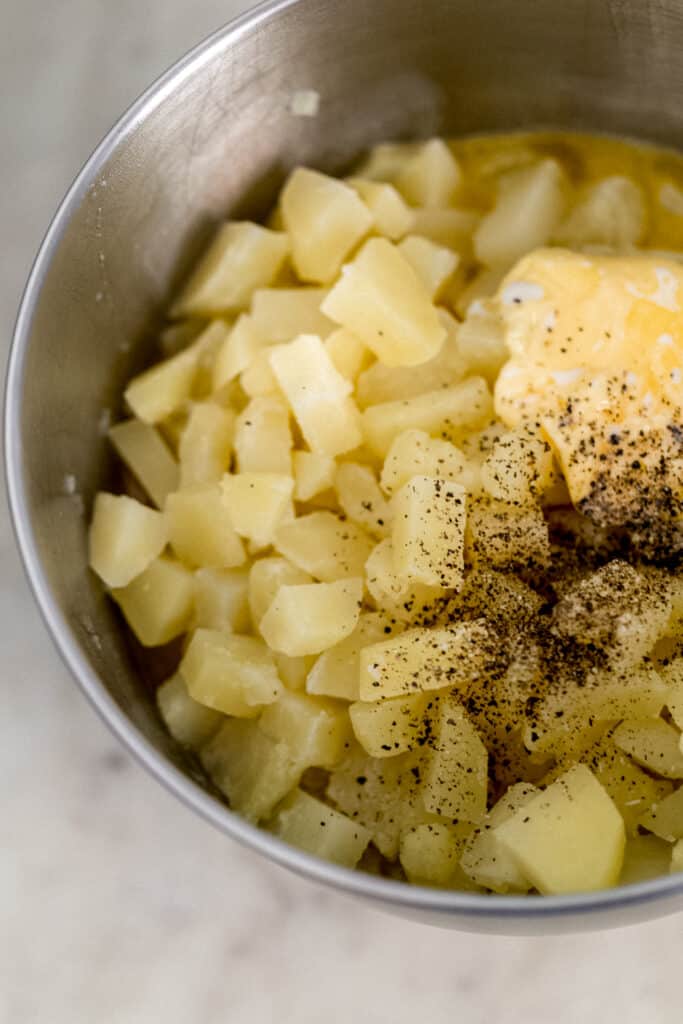 ingredients for mashed potatoes in mixing bowl of stand mixer 