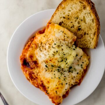 finished pasta and bread on white plate