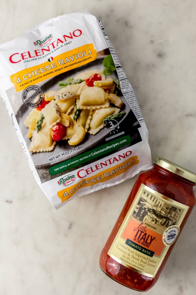 frozen ravioli package and jar of pasta sauce 