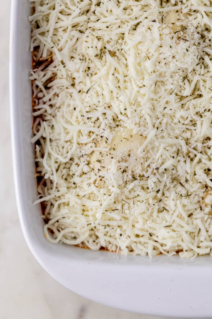 cheesy ravioli bake in baking dish before baking in oven. 