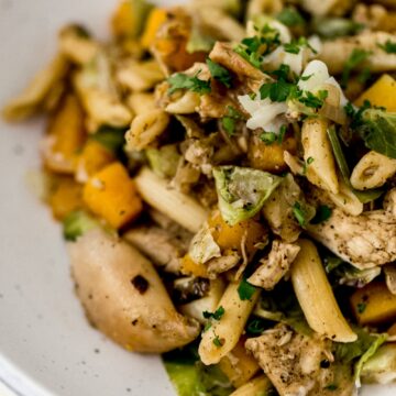close up pasta dish in white bowl