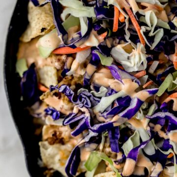 overhead view ground pork nachos in cast iron skillet